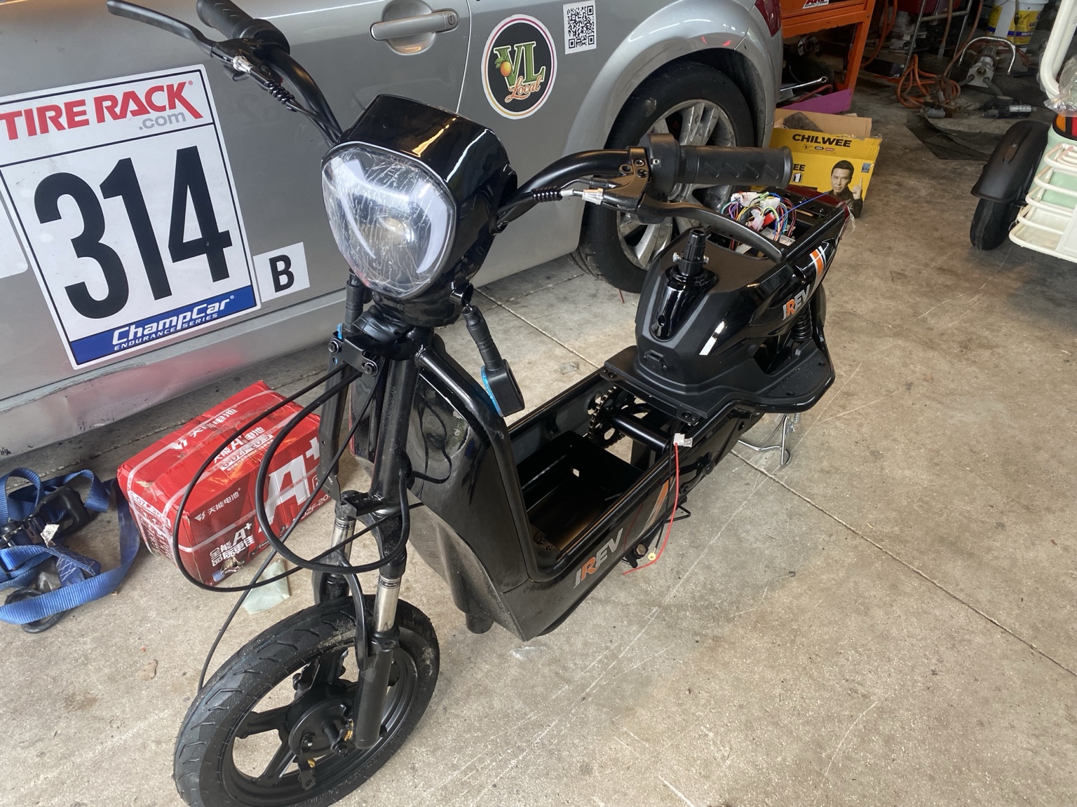 Black iREV electric scooter during assembly — actual item photo